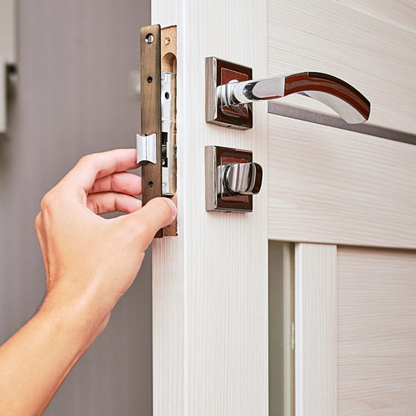 Professional locksmith installing a high-security door lock in Houston, TX.