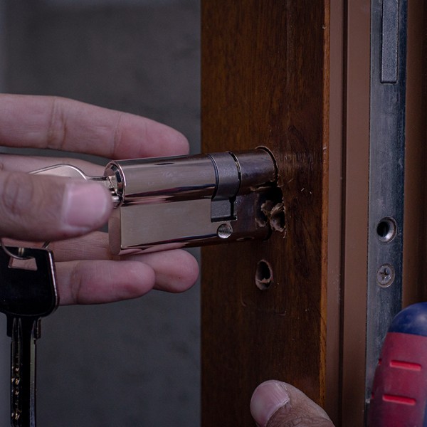 Technician rekeying a residential door lock for a new homeowner.